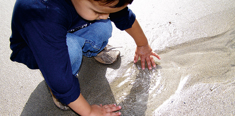 Boy playing on sand