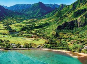 beach by lush, green mountains