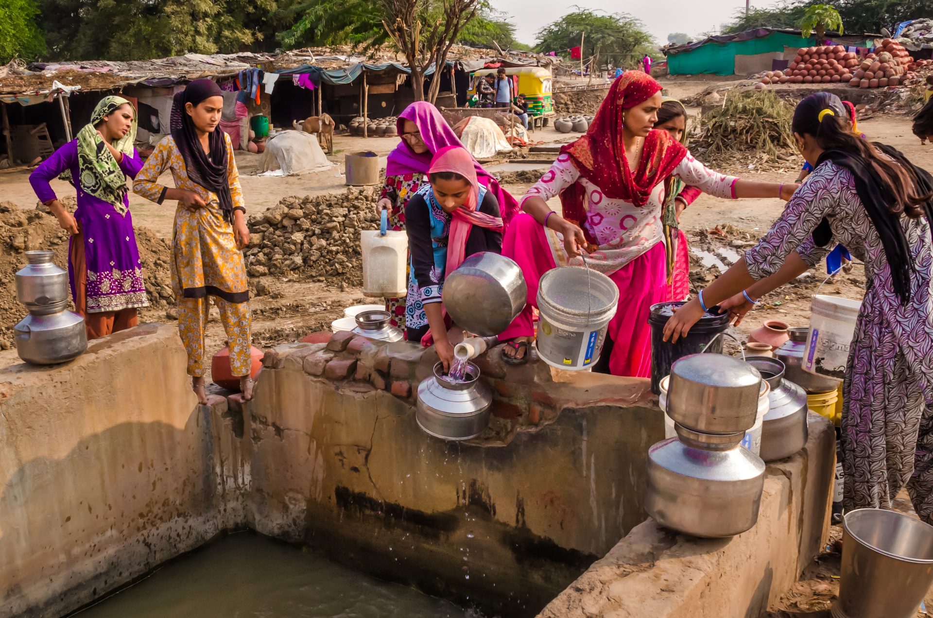 Women from village Makarba gathering water from a water supply nearby well to collect drinking water