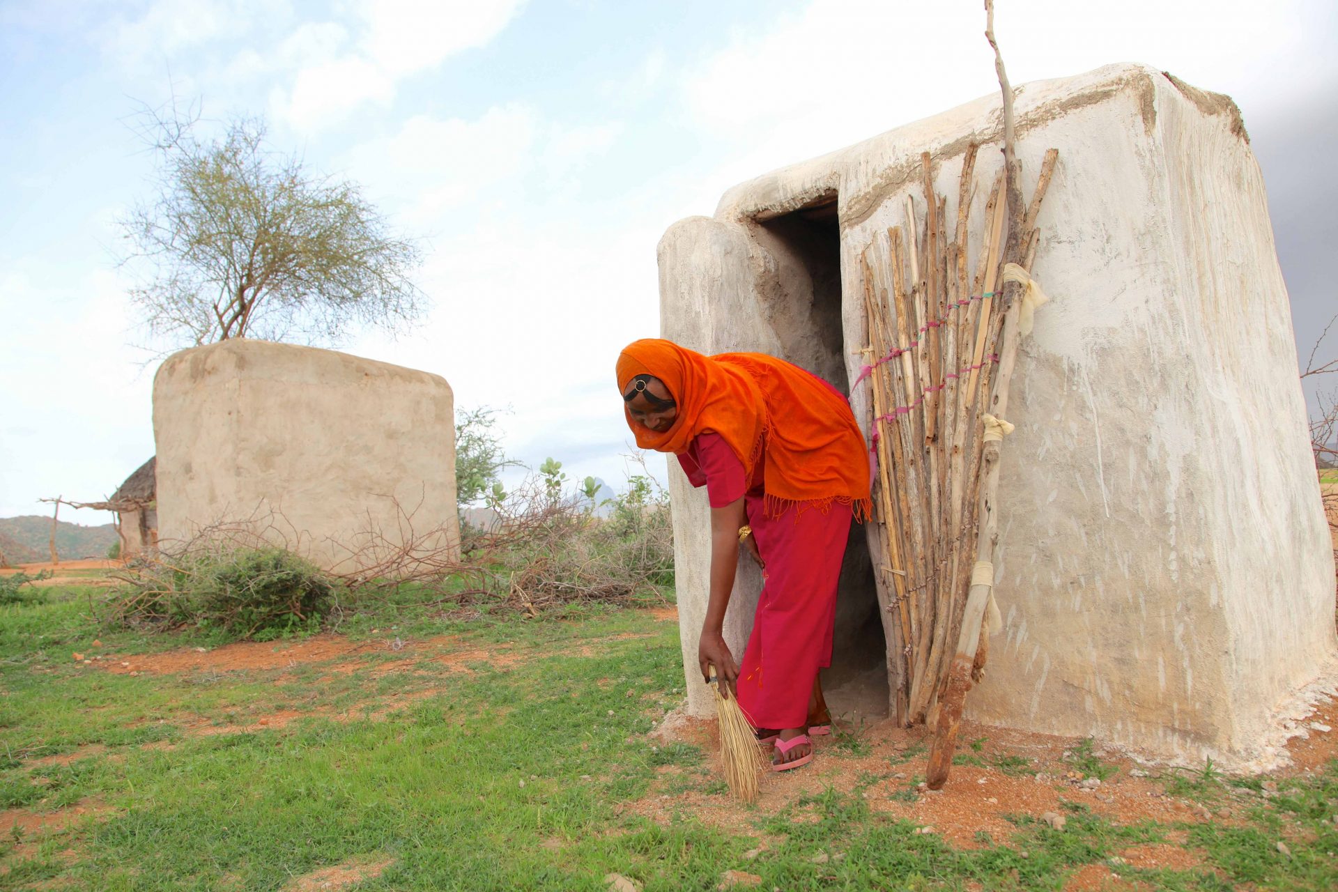 Woman sweeping the front doord