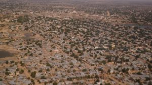 Aerial view of dry landscape with settlements and sparse vegetation.