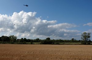 Helicopter hovering over a field