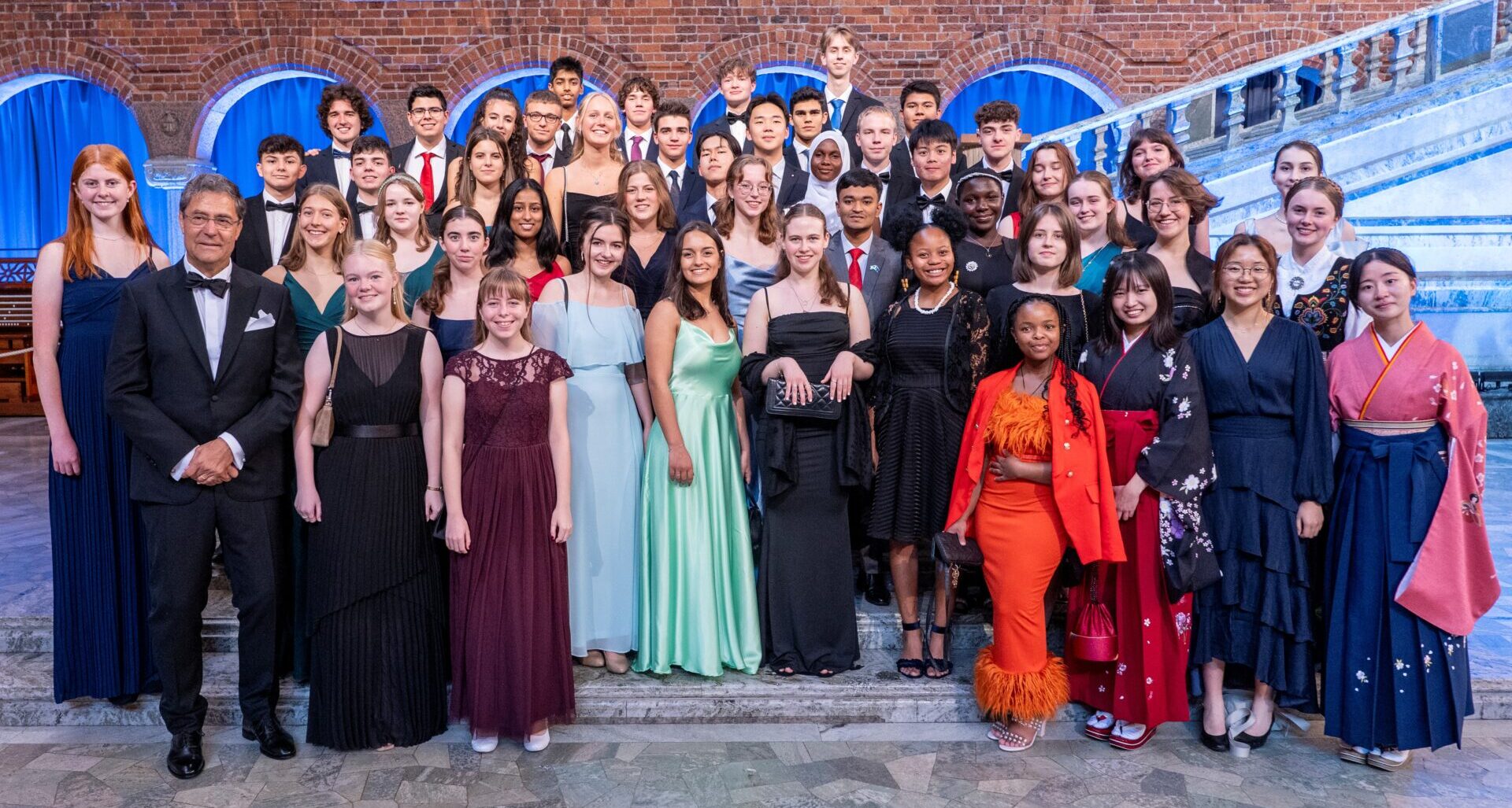 Group of people standing in formal attire