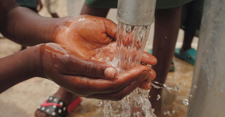 Close up of hands washing under a clear stream of water